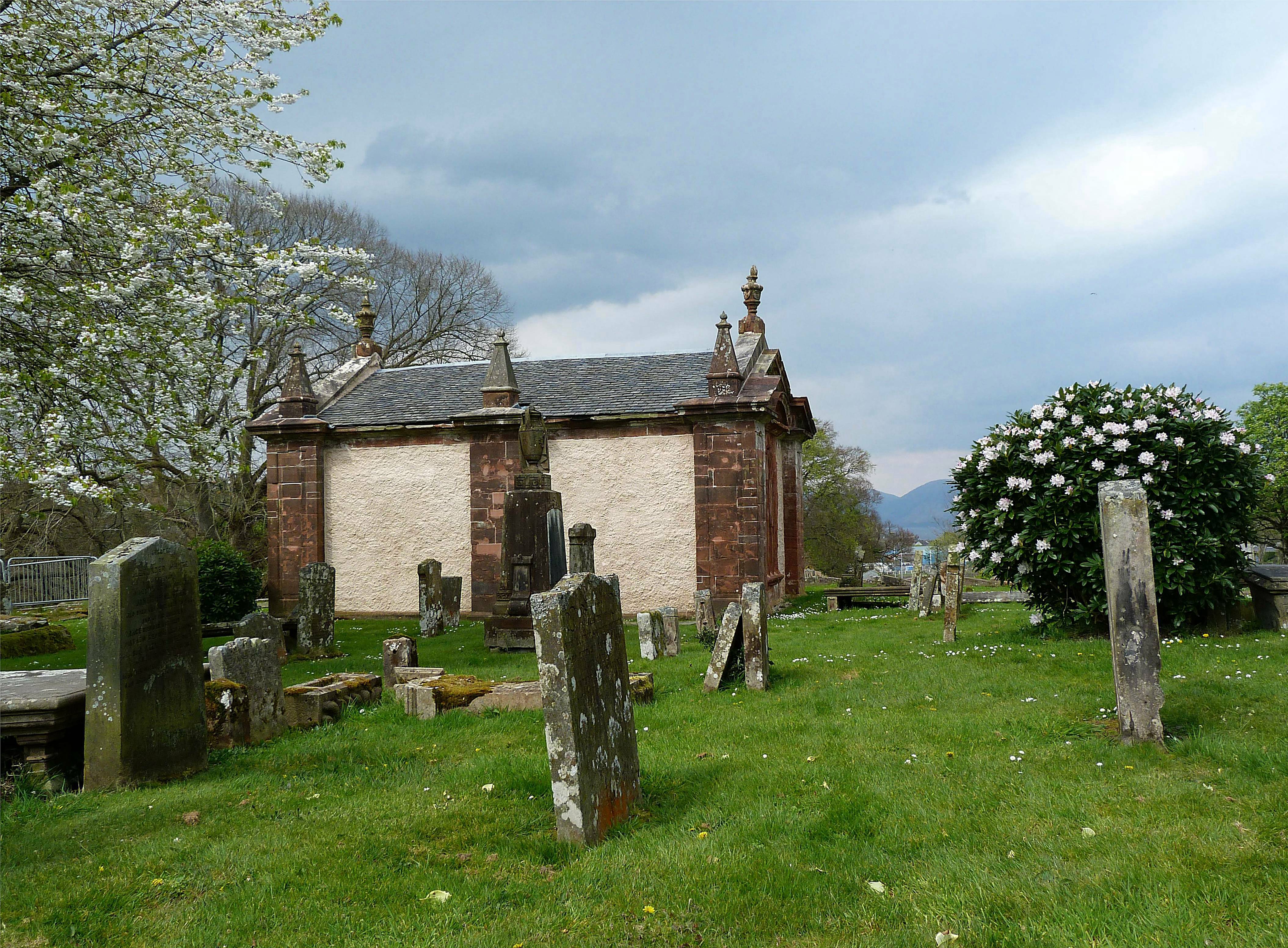 Low stone Bute Mausoleum in the graveyard of the High Kirk of Rothesay, with carved roofline details