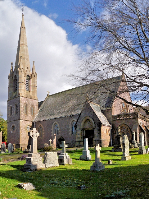 Stone Gothic Revival church of St Andrew in Fort William, with a tall broach spire and churchyard memorials