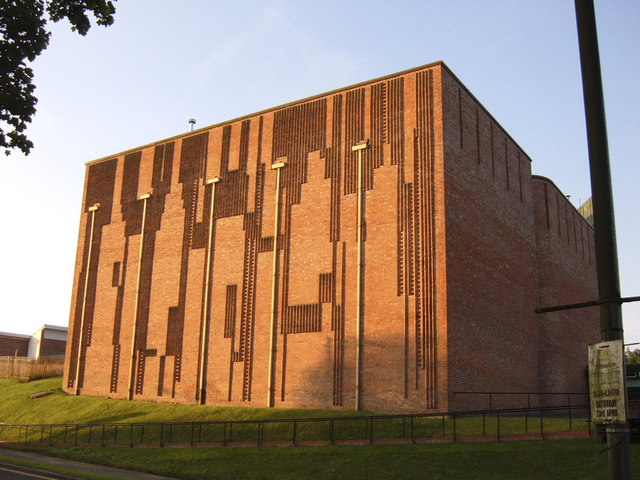 Monumental red-brick side wall of St Bride’s Church in East Kilbride, modelled by vertical ribs and inset crosses