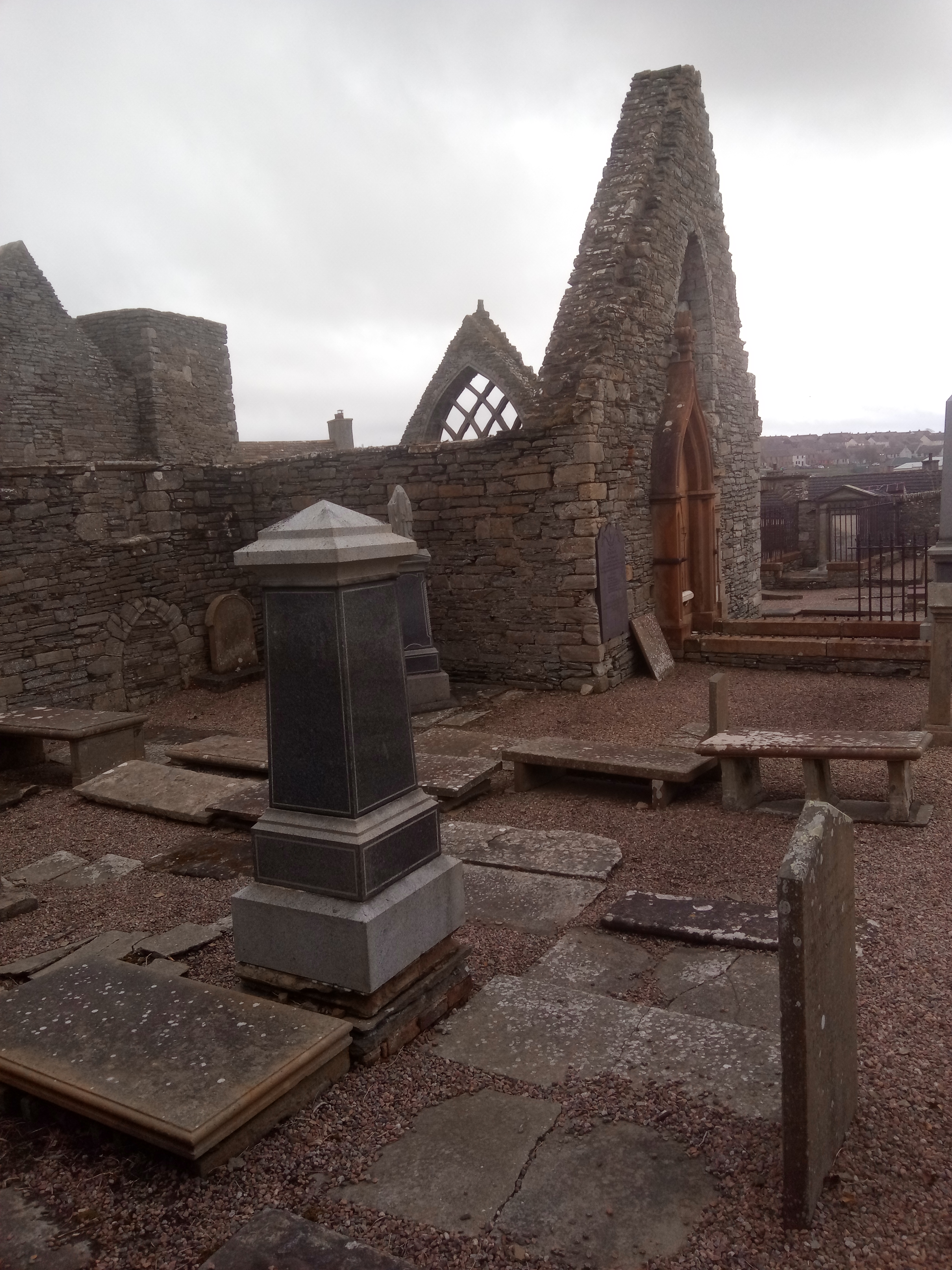 Roofless stone gables and grave monuments within Old St Peter’s Church and Burial Ground in Thurso