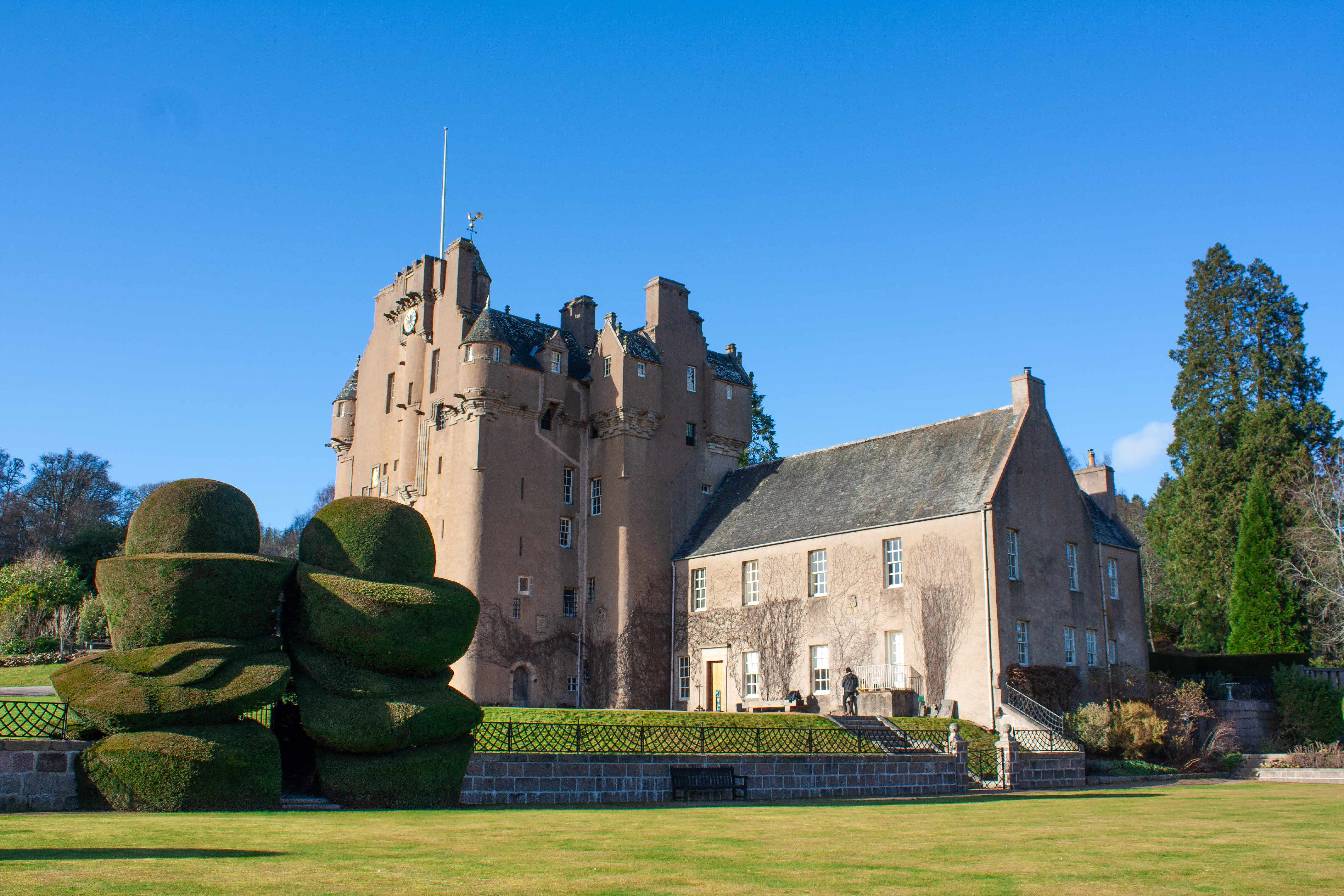 Crathes Castle’s harled walls, turrets and stone stair tower seen from the lawn