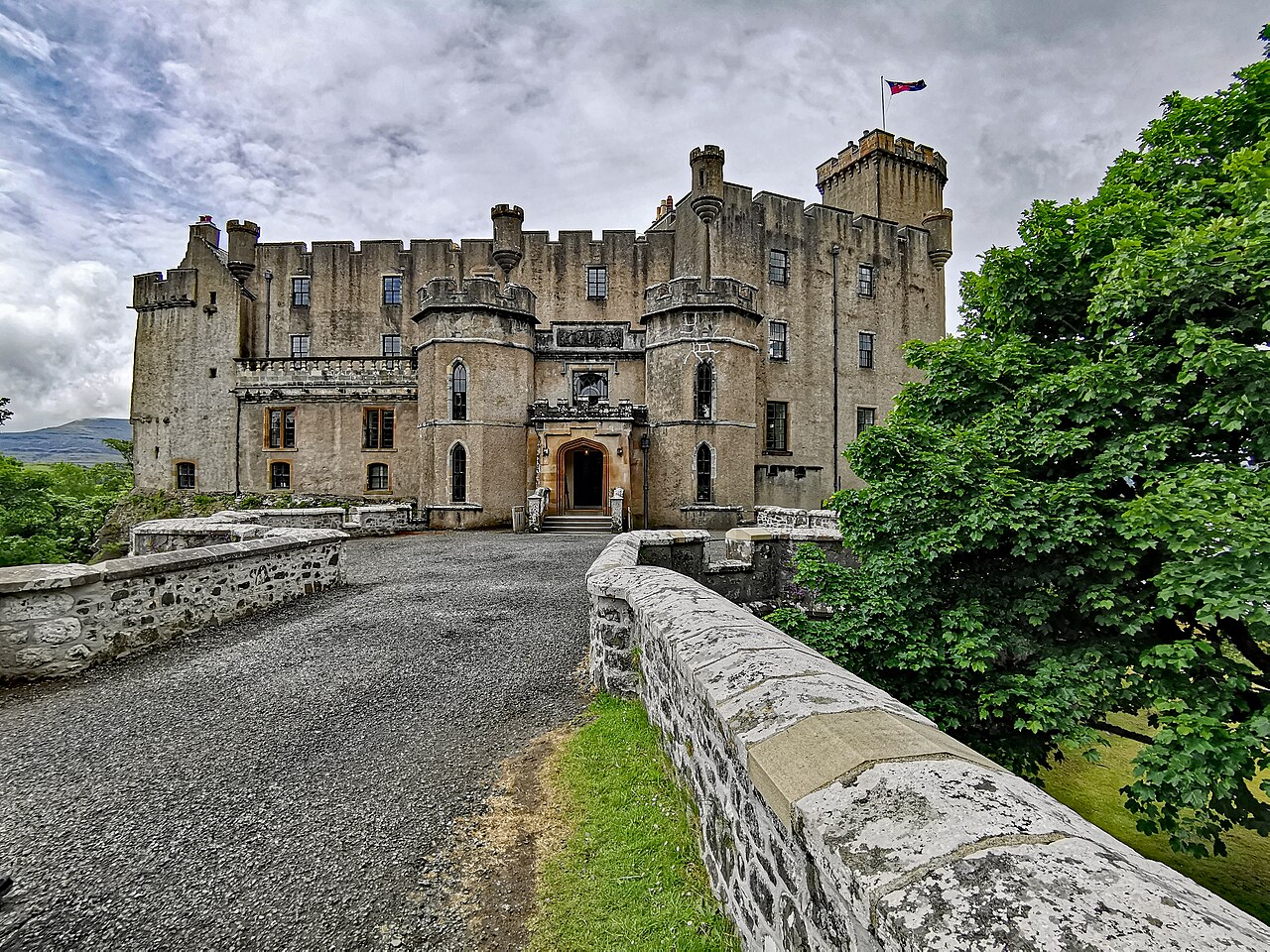 Dunvegan Castle’s white-rendered exterior beside its coastal gardens on Skye