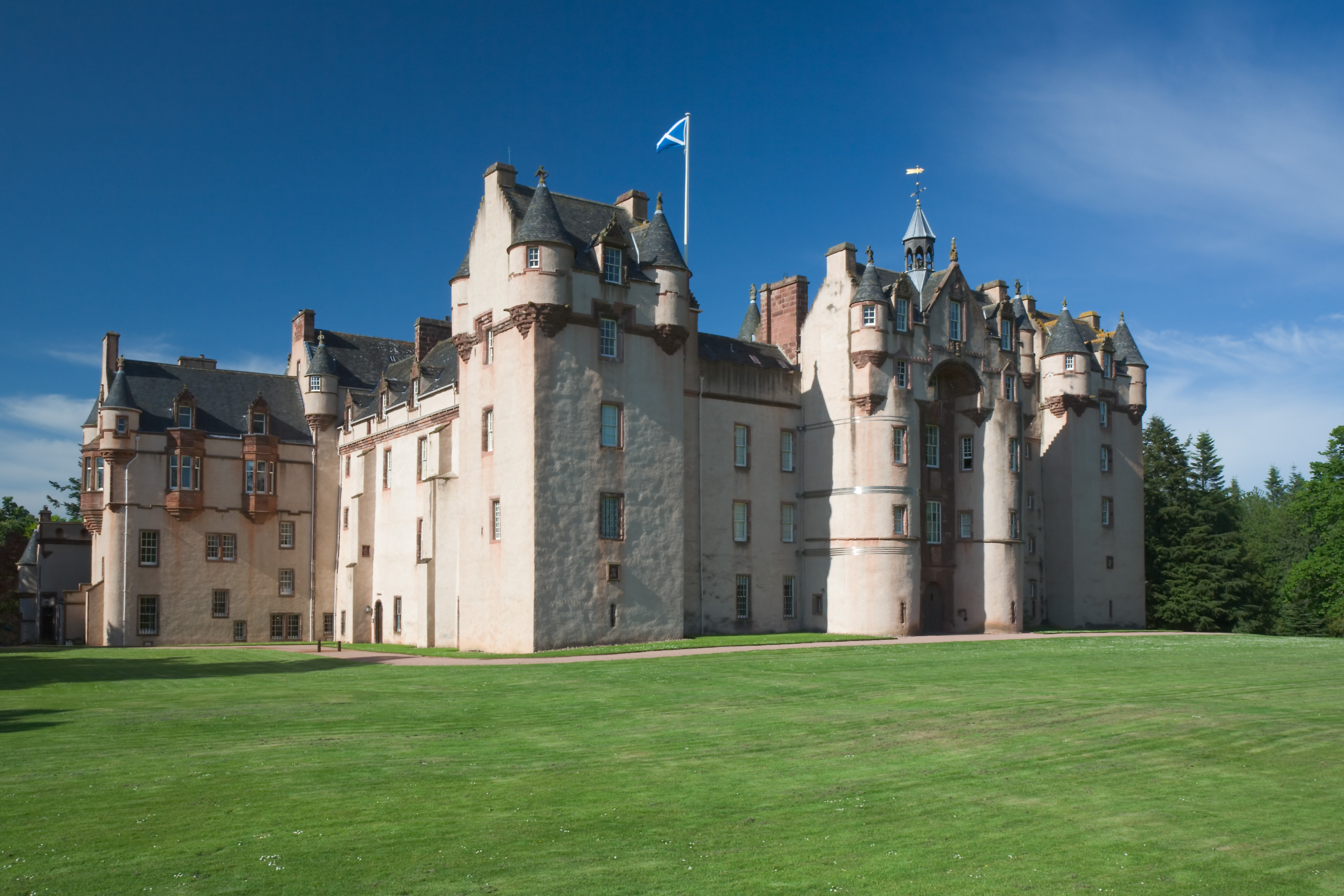 Fyvie Castle’s turreted south and west ranges seen across a lawn