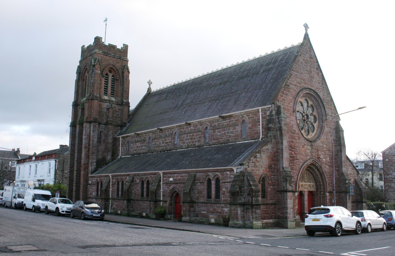 St Michael and All Angels Church in Helensburgh, showing the red sandstone Gothic church and square tower from the street