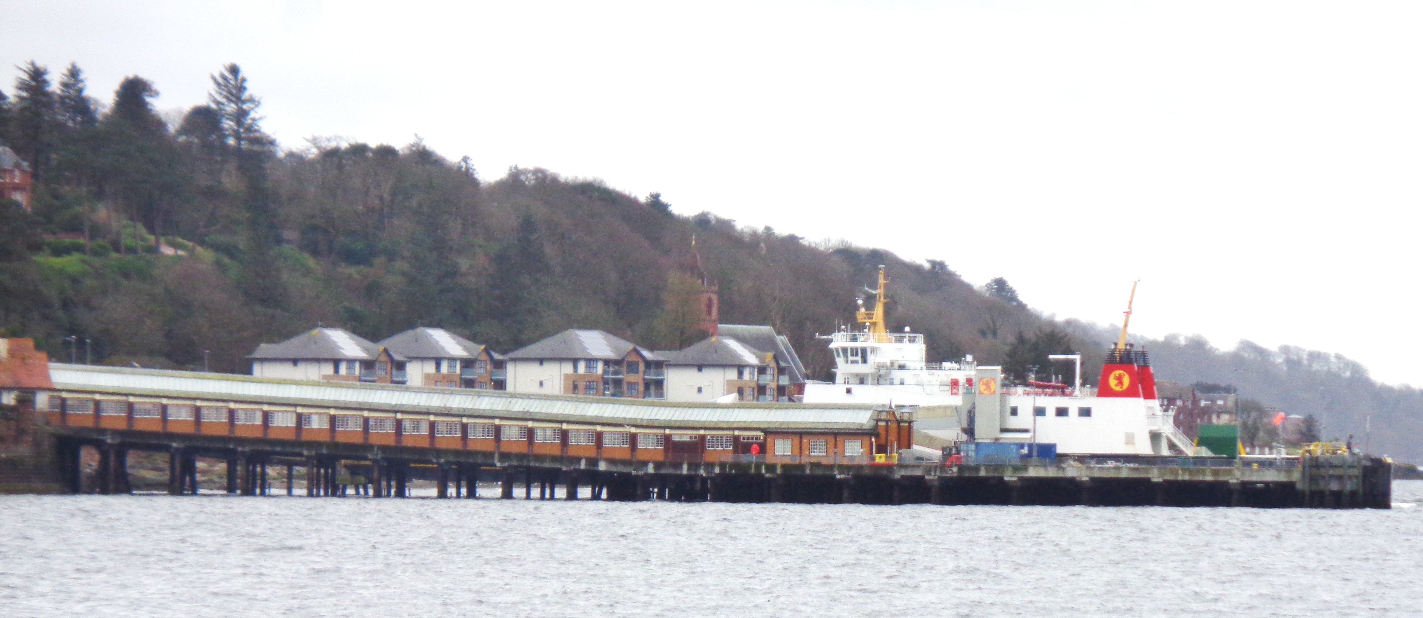 Wemyss Bay Railway Station seen from Wemyss Bay Road, showing its sweeping station roof and clock tower beside the Clyde.