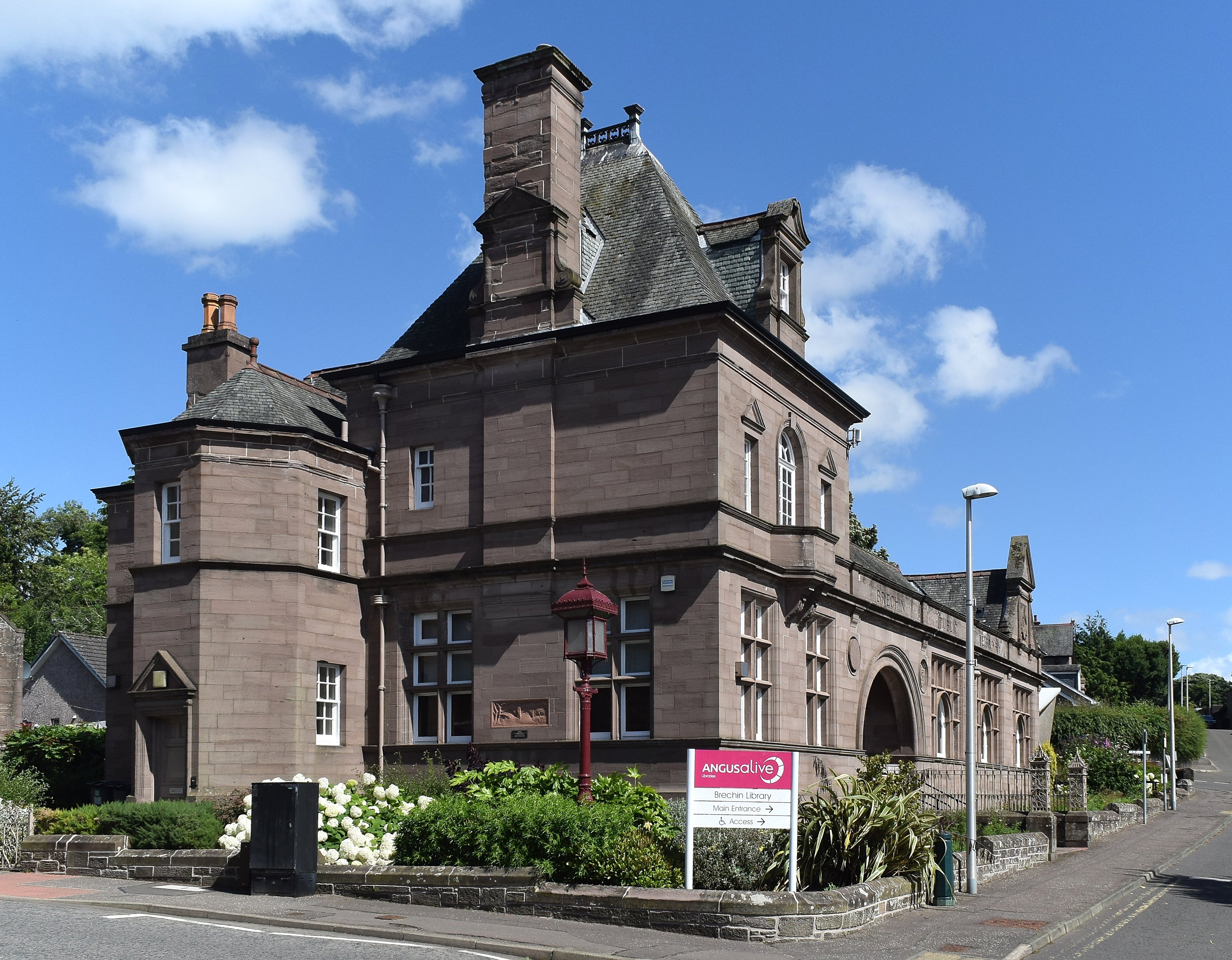 Brechin Public Library’s red-sandstone corner pavilion and adjoining reading-room wing.