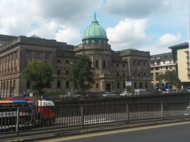 The Mitchell Library in Glasgow, showing its monumental stone exterior and copper dome.