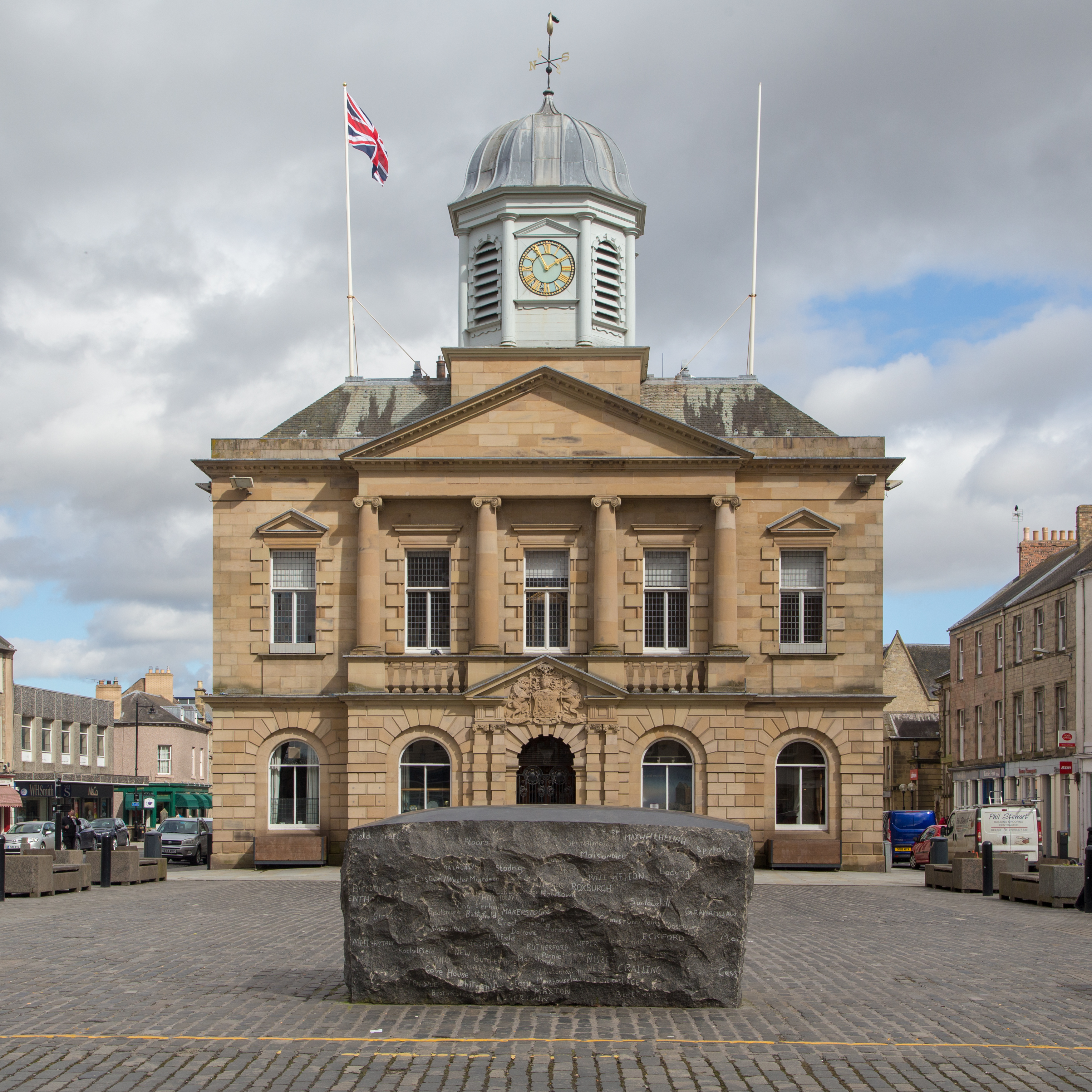 Kelso Town Hall and its clock cupola with the Kelsae Stane in the foreground