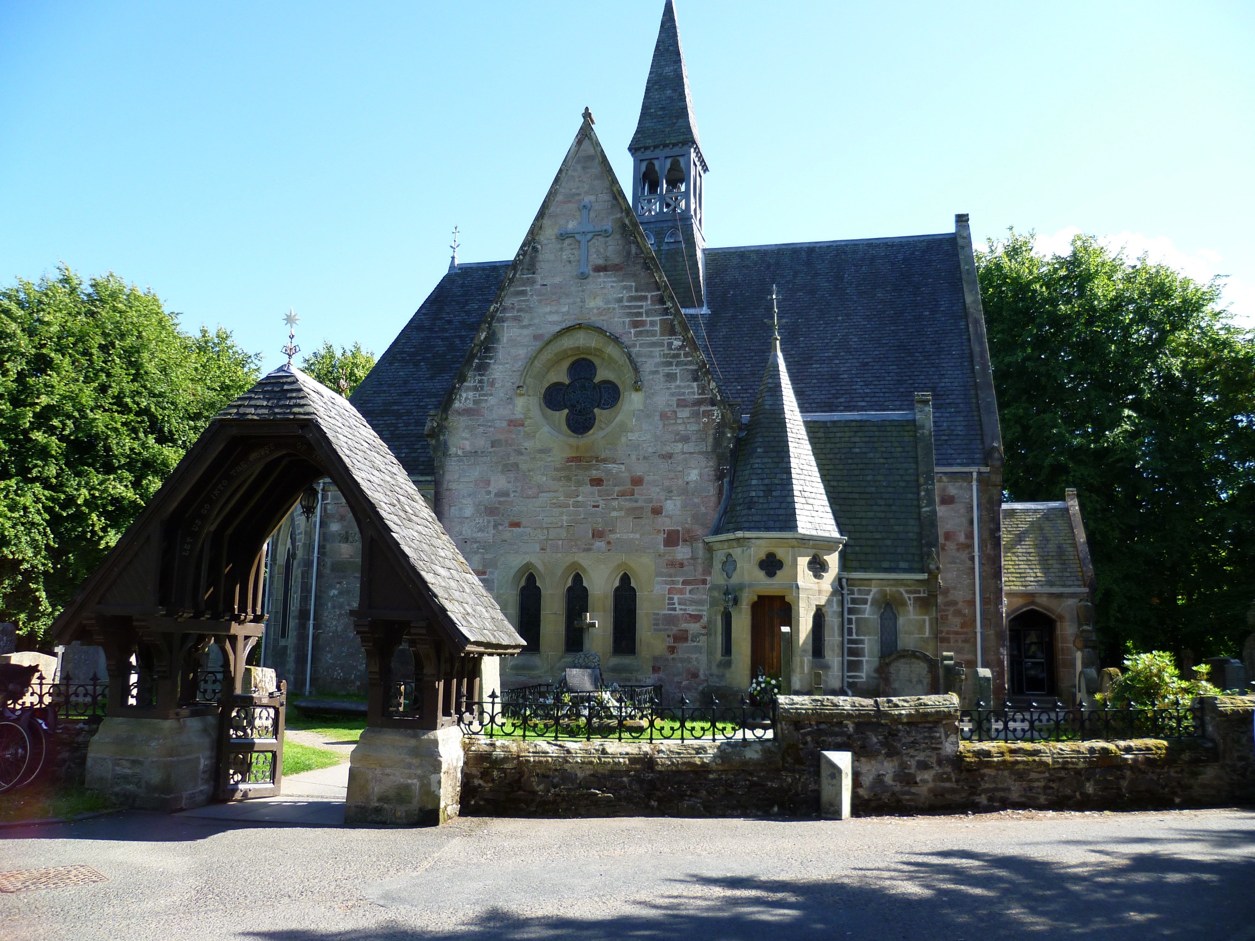 Front view of Luss Parish Church, a stone church with a steep roof and bellcote