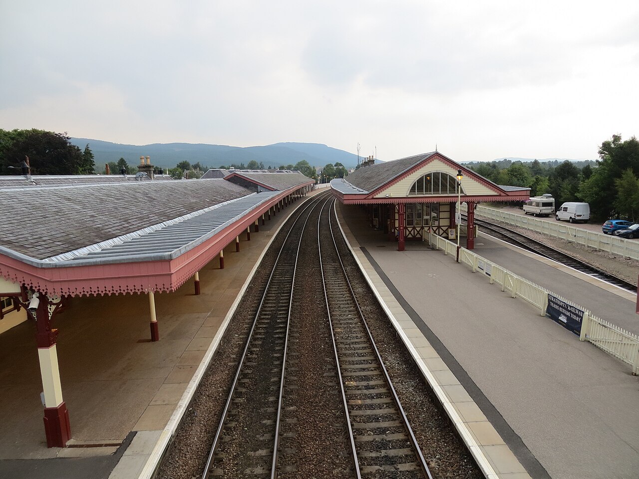 Aviemore Railway Station’s painted timber platform buildings and sweeping awnings, viewed from the footbridge.