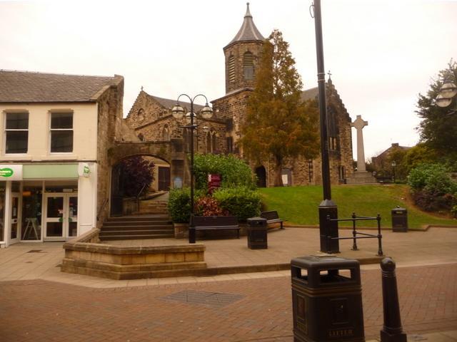 Falkirk Trinity Church’s broad stone façade and tower seen across the pedestrianised High Street.