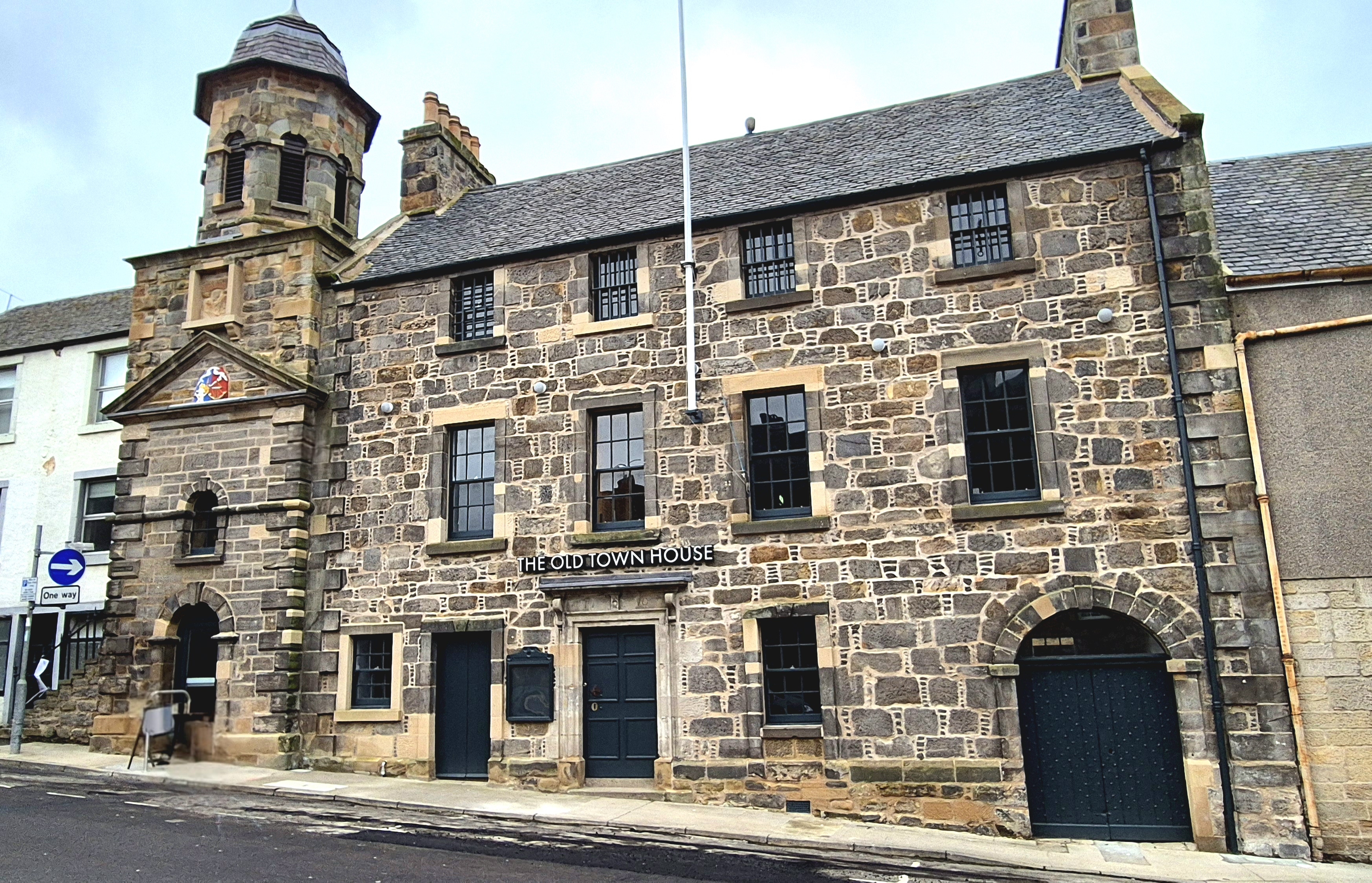Restored Inverkeithing Town House, showing the long stone frontage and ogee-roofed belfry tower.
