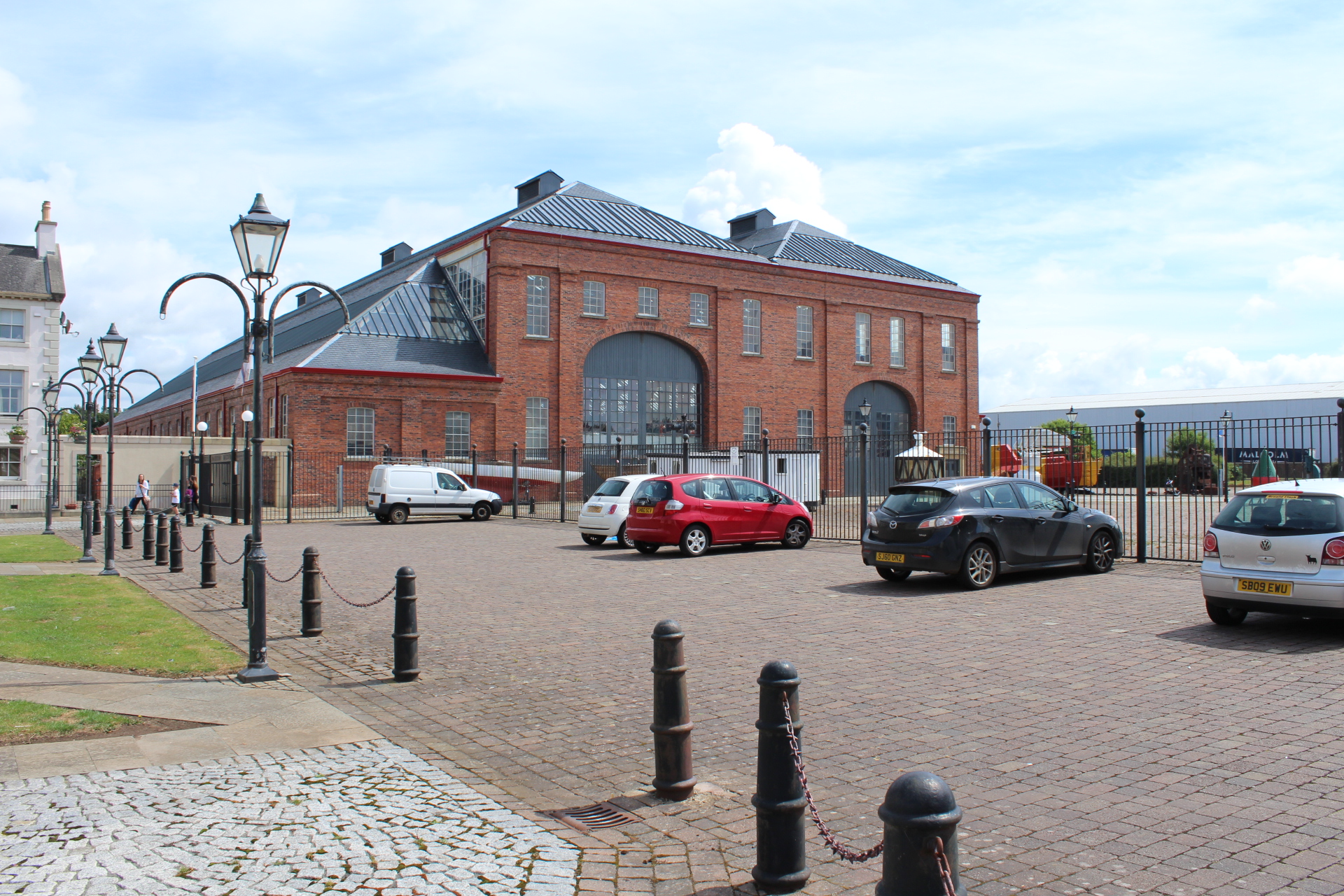 The large red-brick Linthouse Building at the Scottish Maritime Museum in Irvine, with tall arched workshop openings and long side aisles.