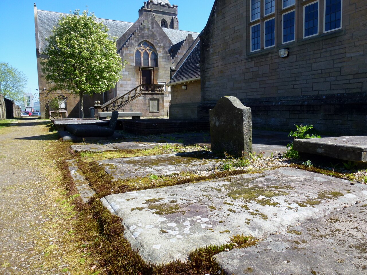 The former Old West Kirk in Greenock, a low stone church with pointed windows and a small bellcote.